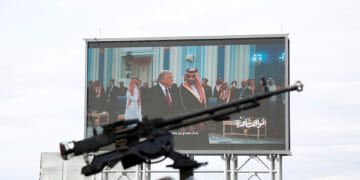 Houthis-mounted machine gun across from screen of Donald Trump meeting with Middle Eastern leaders.