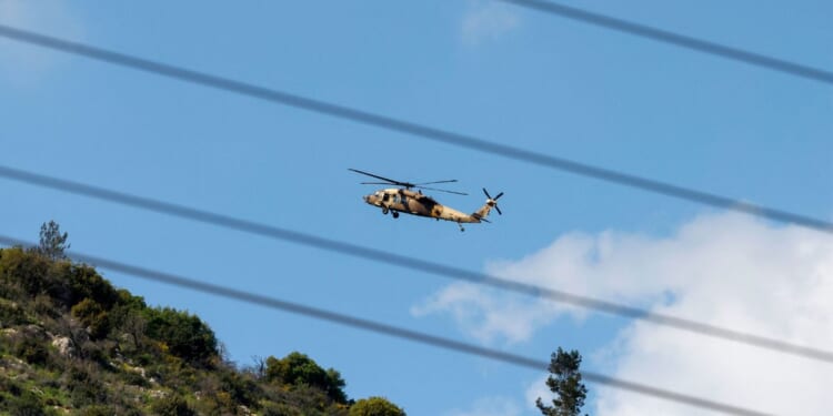 An Israeli Air Force UH-60 Black Hawk helicopter flies over the border area with southern Lebanon in northern Israel on March 2, 2026.