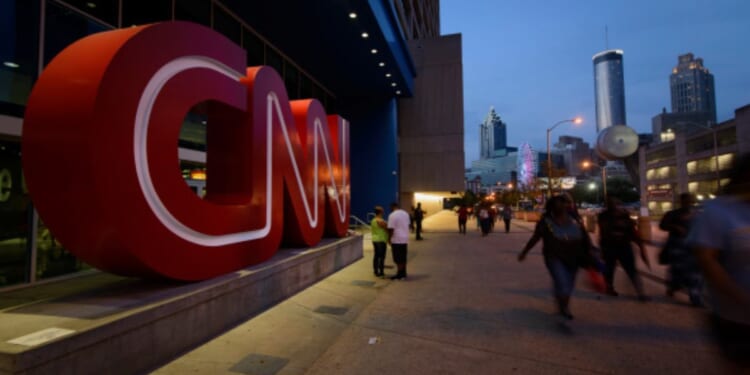 People walk past the CNN Headquarters in Atlanta, Georgia, on Aug. 2, 2014.