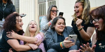 Laura Marquez-Garrett, center, in gray blazer, plaintiffs' attorney for the Social Media Victims Law Center, celebrates with family members of victims outside the Los Angeles Superior Court Wednesday as they react to news that a jury has found Meta and YouTube liable in a social media addiction trial. The jury found Meta and YouTube liable for harming a young woman through the addictive design of their social media platforms and ordered the companies to pay $3 million in damages.