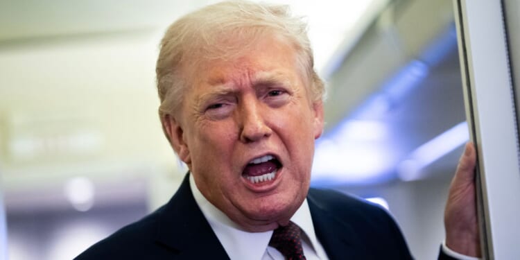 President Donald Trump speaks to media members onboard Air Force One on March 15, 2026.