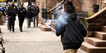 A violent leftist holds a homemade explosive device before throwing it into a right-wing anti-"Islamification" protest outside Mayor Zohran Mamdani's mansion in New York on March 7, 2026.