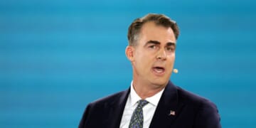 Gov. Kevin Stitt of Oklahoma speaks at the Bloomberg New Economy Forum in Singapore on Nov. 21, 2025.