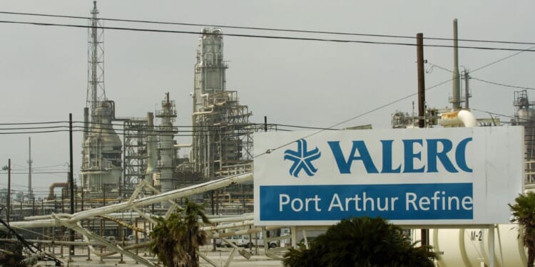 Damage to supply pipes and a sign are seen at the idle Valero oil refinery on Sept. 25, 2005, in Port Arthur, Texas, in the aftermath of Hurricane Rita.