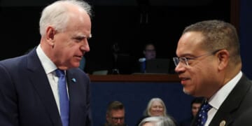 Minnesota Gov. Tim Walz speaks to Minnesota Attorney General Keith Ellison, right, as they arrive to testify during a House Oversight and Government Reform Committee hearing Wednesday in Washington, D.C. The committee held the hearing to examine the alleged misuse of federal funds intended for Minnesota social services and Medicaid programs.