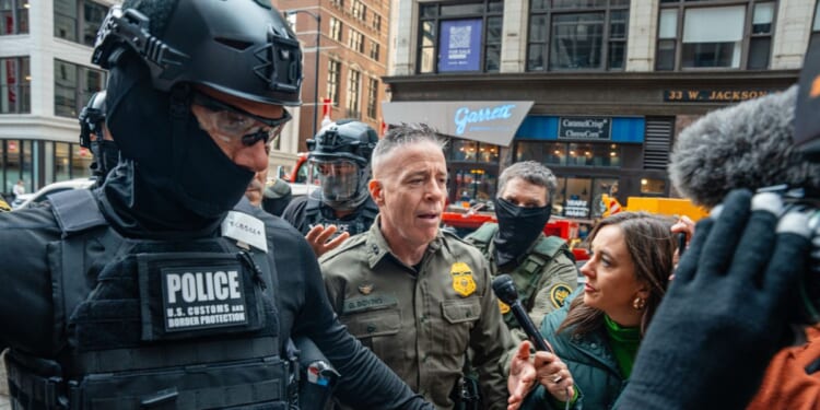 U.S. Border Patrol commander Gregory Bovino pushes through a crowd of media and protesters as he enters the Dirksen Federal Building on Oct. 28 in Chicago, Illinois, to meet with U.S. District Judge Sara Ellis. A federal appeals court last week ruled against what it called Ellis' "sweeping preliminary injunction" that attempted to regulate "all federal immigration enforcement efforts districtwide."