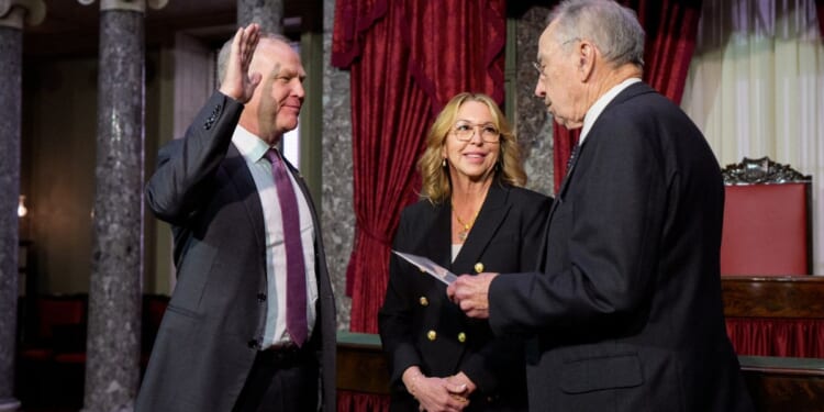 GOP Sen. Alan Armstrong of Oklahoma, accompanied by his wife Shelly, participates in a ceremonial swearing in ceremony Tuesday with Senate President Pro Tempore Charles Grassley, an Iowa Republican, in the Old Senate Chamber at the U.S. Capitol Building in Washington, D.C. Armstrong, a longtime petroleum executive, was sworn in as an interim Senator for Oklahoma to replace Markwayne Mullin, who was tapped to replace Kristi Noem as the new secretary of homeland security.