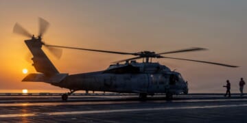 In this handout released by the U.S. Navy, an MH-60S Sea Hawk helicopter, attached to Helicopter Sea Combat Squadron (HSC) 14, lands on the flight deck of the Nimitz-class aircraft carrier USS Abraham Lincoln (CVN 72) in support of Operation Epic Fury on March 2, 2026.
