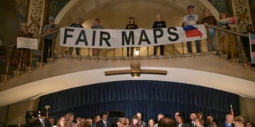 Activists display signs during a press conference inside the rotunda of the Missouri State Capitol Building on Sept. 10, 2025, in Jefferson City, Missouri.