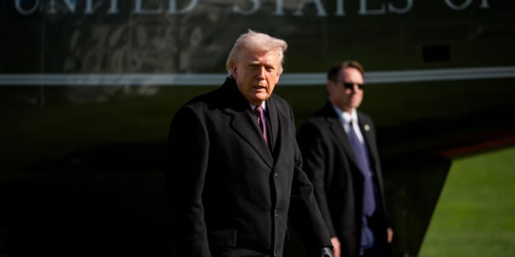 President Donald Trump steps of Marine One as he returns to the White House on March 18, 2026, in Washington, D.C.