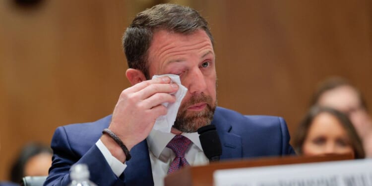 Republican Sen. Markwayne Mullin becomes emotional as he testifies at a confirmation hearing in Washington, DC, on March 18, 2026.