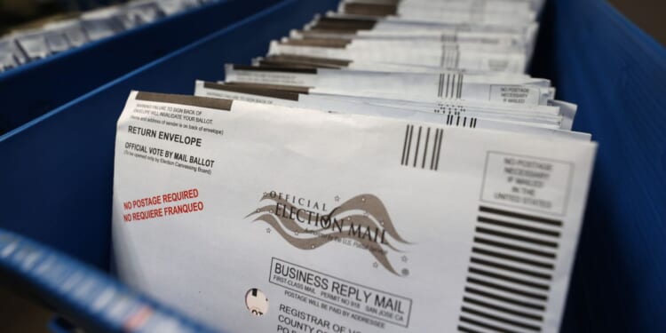 Mail-in ballots sit in trays at the Santa Clara County registrar of voters office in a file photo from Oct. 13, 2020, in San Jose, California.