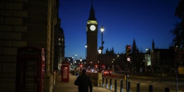 A pedestrian walks down the street toward Big Ben and the Houses of Parliament in Westminster in central London, early morning on Nov. 26, 2025, ahead of the government's budget presentation.