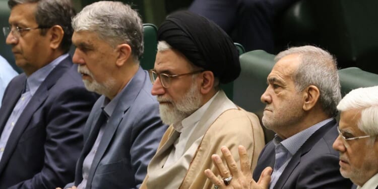 Iran's Minister of Intelligence Esmail Khatib, center, is pictured on Aug. 17, 2024, with Iran's President Masoud Pezeshkian (center right) before a speech to members of parliament in Tehran. Khatib was reportedly killed Tuesday night.