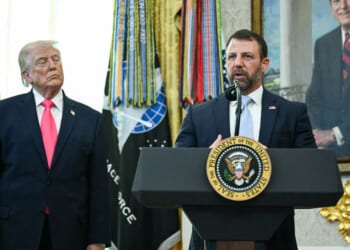 President Donald Trump watches as Secretary of Homeland Security Markwayne Mullin speaks in the Oval Office of the White House on March 4, 2026 in Washington, DC.