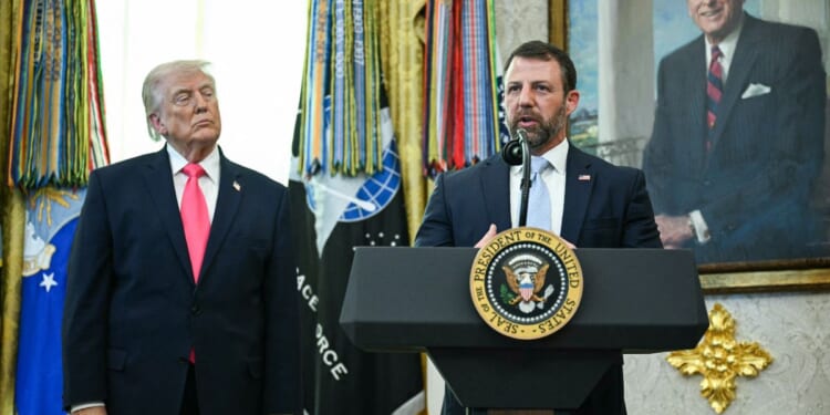 President Donald Trump watches as Secretary of Homeland Security Markwayne Mullin speaks in the Oval Office of the White House on March 4, 2026 in Washington, DC.