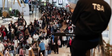 Huge lines of passengers clog New York's LaGuardia airport on Sunday,