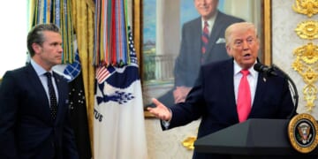 President Donald Trump takes questions as Secretary of War Pete Hegseth looks on during a ceremony for newly sworn in Secretary of the Department of Homeland Security Markwayne Mullin in the Oval Office at the White House on March 24, 2026, in Washington, D.C.