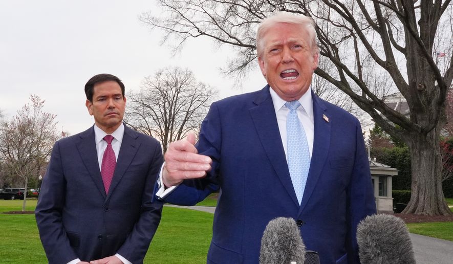 President Donald Trump speaks with reporters before departing on Marine One from the South Lawn of the White House, Friday, March 20, 2026, in Washington, as Secretary of State Marco Rubio listens. (AP Photo/Alex Brandon)