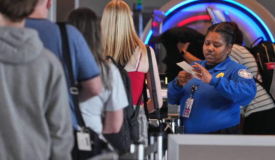 A TSA worker checks passengers at Greater Pittsburgh International Airport in Imperial, Pa., Thursday, March 26, 2026. (AP Photo/Gene J. Puskar)