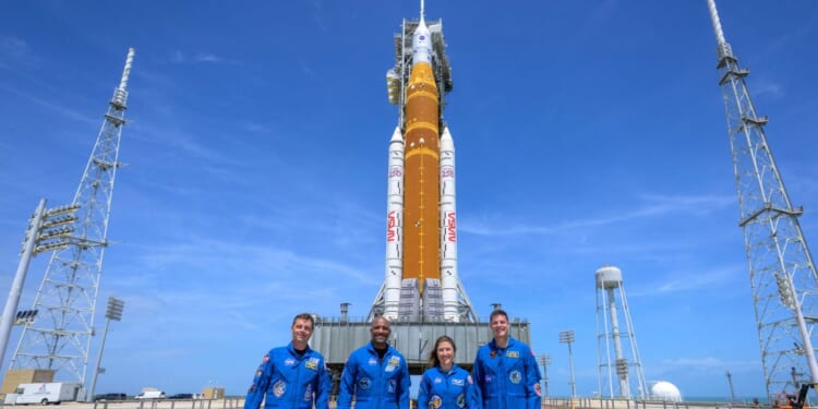 In this handout provided by NASA, NASA astronauts Reid Wiseman, Artemis II commander, left, Victor Glover, Artemis II pilot, Christina Koch, Artemis II mission specialist, and Canadian Space Agency astronaut Jeremy Hansen, Artemis II mission specialist, right, stop for a group photograph as they visit NASA's Artemis II Space Launch System rocket and Orion spacecraft, on March 30, 2026, in Cape Canaveral, Florida.