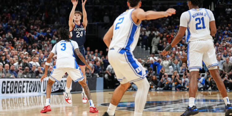 A guard playing for the University of Connecticut scores the winning basket in a game against Duke in the Elite Eight of the NCAA college basketball tournament on March 29, 2026.