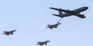 An Israeli KC-135 Stratotanker Boeing 707 plane refuels an F-15 fighter jet as they take part in an air show for a graduation ceremony at the Hatzerim base in the Negev desert, near the southern Israeli city of Beersheva, on Dec. 31, 2015.