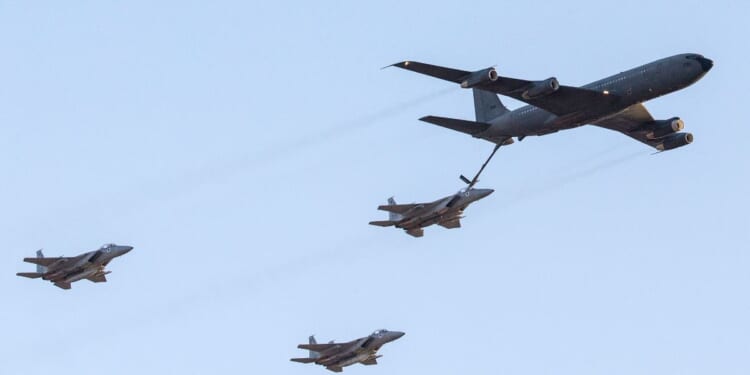 An Israeli KC-135 Stratotanker Boeing 707 plane refuels an F-15 fighter jet as they take part in an air show for a graduation ceremony at the Hatzerim base in the Negev desert, near the southern Israeli city of Beersheva, on Dec. 31, 2015.