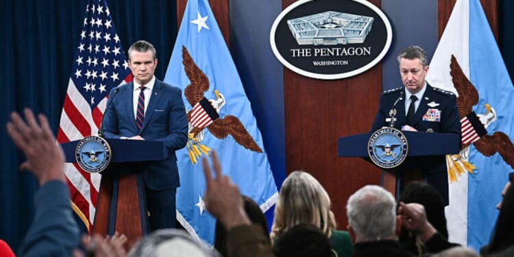 Secretary of War Pete Hegseth, left, and the Chairman of the Joint Chiefs of Staff General Dan Caine, right, take questions during a news conference Monday on U.S. military action in Iran, at the Pentagon in Washington, D.C.