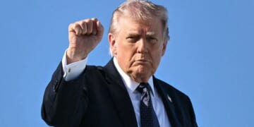 President Donald Trump gestures as he boards Air Force One Sunday at Palm Beach International Airport in West Palm Beach, Florida.