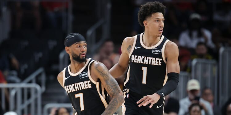 Jalen Johnson and Nickeil Alexander-Walker of the Atlanta Hawks react against the Philadelphia 76ers during a game at State Farm Arena on March 7, 2026, in Atlanta, Georgia.