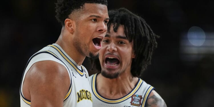 Michigan muscles its way to program’s 2nd national title, beating stubborn UConn