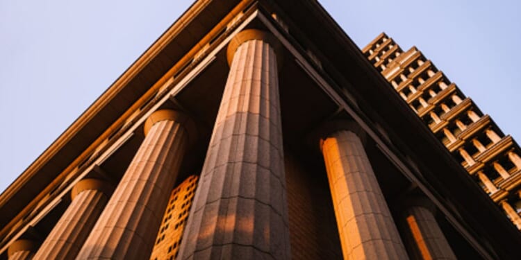 A Neoclassical building stands.