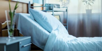 A side view of an empty hospital bed in a clinic.