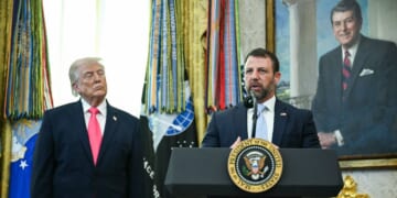 President Donald Trump looks on as newly sworn in Secretary of Homeland Security Markwayne Mullin speaks in the Oval Office of the White House in Washington, D.C., on March 24, 2026.