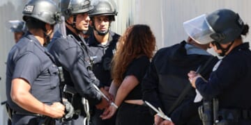 LAPD officers arrest an anti-ICE protester on April 11, 2026.