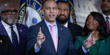 Hakeem Jeffries points upward during press conference with fellow Democrats.