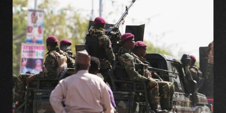 Soldiers patrol the streets in northern Nigeria in a file photo from Feb. 13. More thanr 25 people were killed over Easter weekend during several attacks in Nigeria.