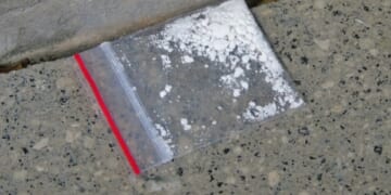 A stock photo shows a small amount of cocaine in a Ziploc baggie.