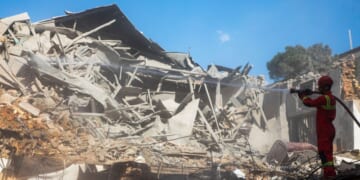 Emergency crews work at the site of a U.S.-Israeli strike Tuesday on what was described as a residential building adjacent to Rafi-Nia Synagogue in Tehran, Iran.