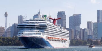 Large Carnival Splendor cruise ship sailing in Sydney Harbor with the skyline in the background in Sydney in the state of New South Wales in southeastern Australia on Feb. 13, 2025.
