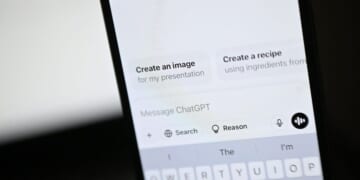 An illustration photograph taken on Feb. 20, 2025, shows the ChatGPT app and website are displayed on a phone and laptop screens, in a residential property in Guildford, south of London.