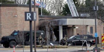 Law enforcement remain on site at the Temple Israel synagogue in West Bloomfield, Michigan, a Detroit suburb, on March 12, 2026, after an assailant drove a vehicle into the building.