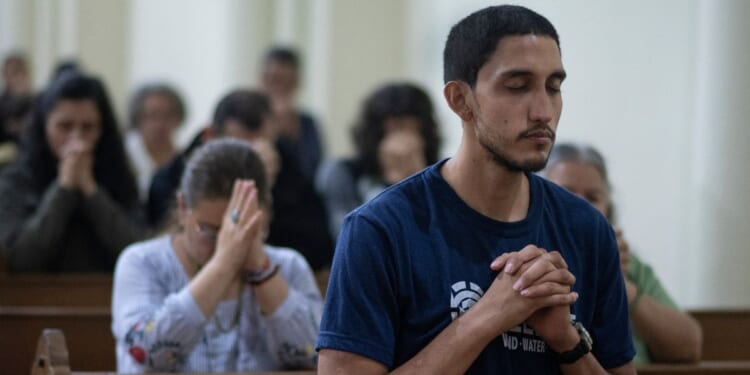Nicaraguans attend a mass during celebrations in a church in San Jose, Costa Rica, on Dec. 7, 2023.