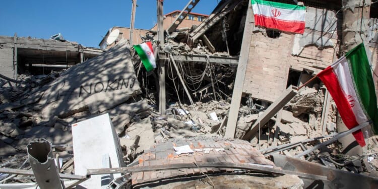 Iranian flags and graffiti seen at the remains of Sharif University of Technology in Tehran, Iran on April 7, 2026.