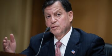 Frank Bisignano speaking into a microphone