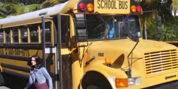 A girl getting off a school bus