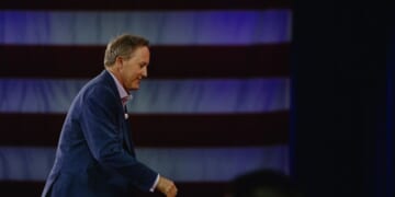 Texas Attorney General Ken Paxton leaves CPAC stage.