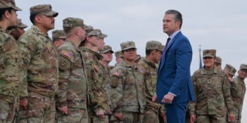 Secretary of War Pete Hegseth congratulates a group of National Guard troops after administering their re-enlistment ceremony at the base of the Washington Monument on Feb. 6, 2026, in Washington, D.C.