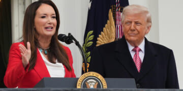 President Donald Trump listens to Agriculture Secretary Brooke Rollins speak during an event with farmers on the South Lawn of the White House on Friday, March 27, 2026, in Washington, D.C.